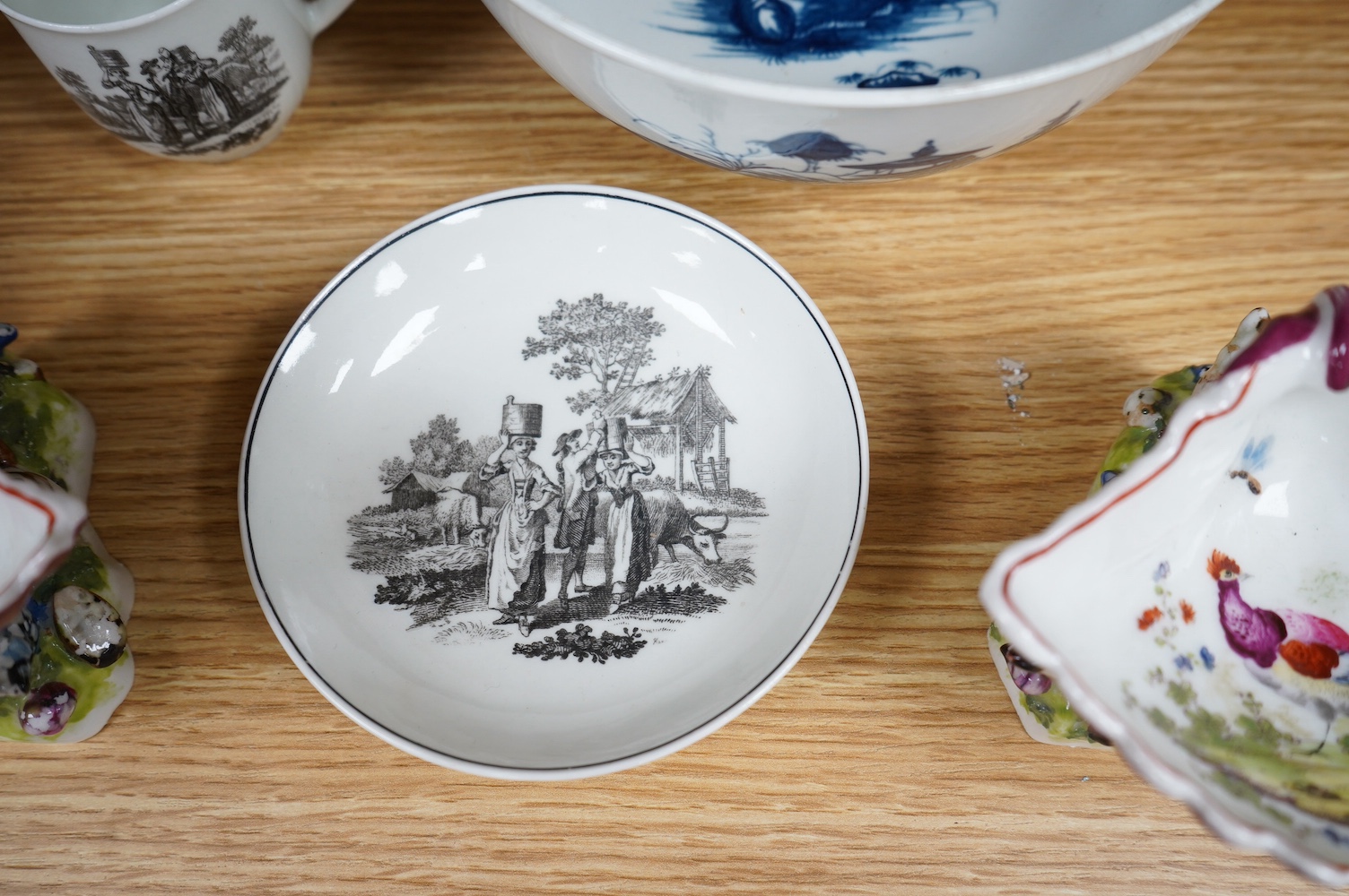 A Worcester coffee cup and saucer, Milkmaid pattern by Hancock, a pair of English porcelain shell salts, and a Worcester blue and white bowl, 18cm (5). Condition - fair